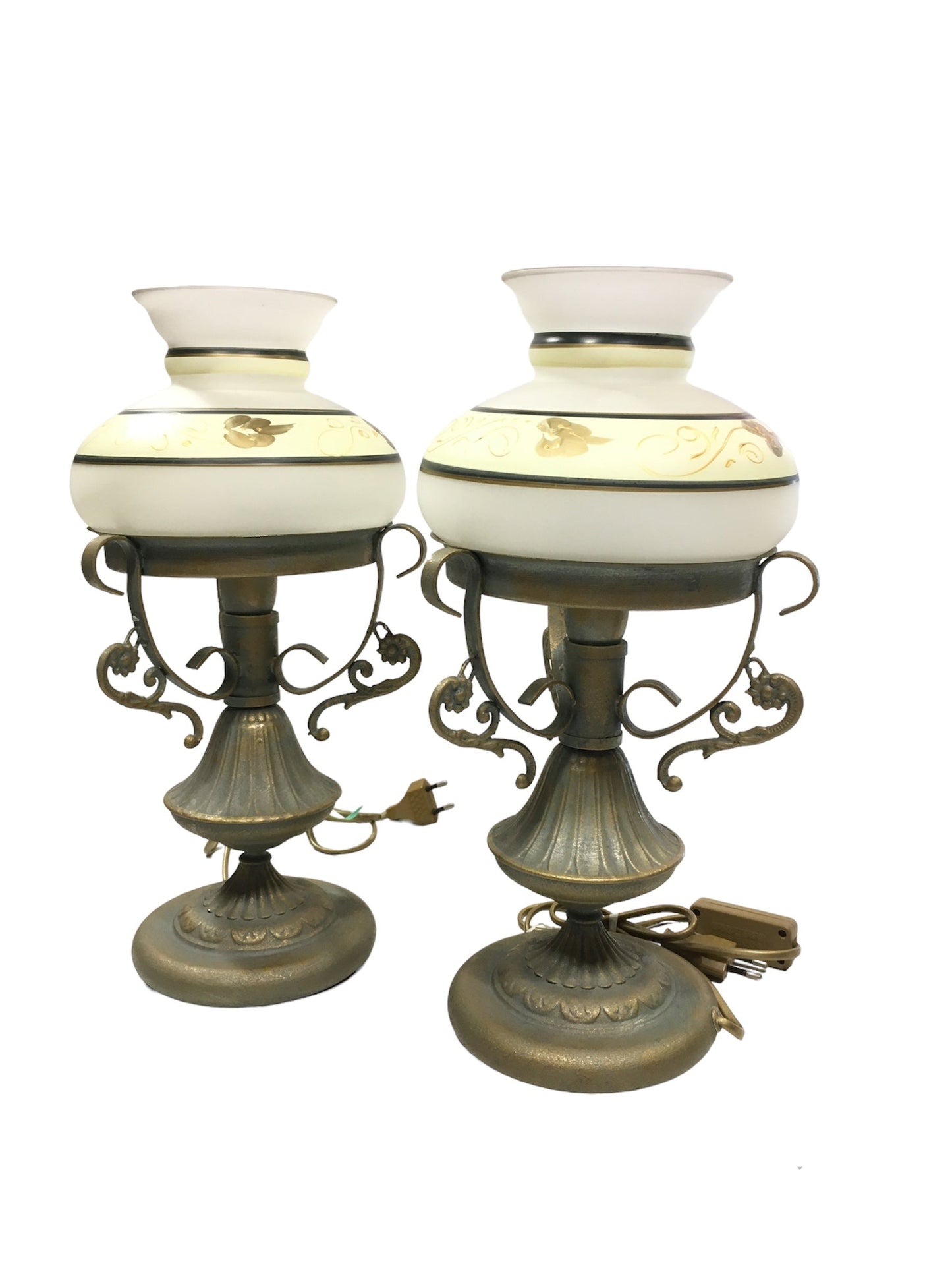 Set di 2 lampade in stile classico in metallo di colore oro e verde (effetto verderame), coppe in vetro sabbiato decorate a mano. Corredate di cavo con interruttore, funzionano con una lampadina attacco piccolo E14 (non incluse). Dimensioni: cm 18 x 37 h - base cm 14. In negozio e online su tuttochic.it
