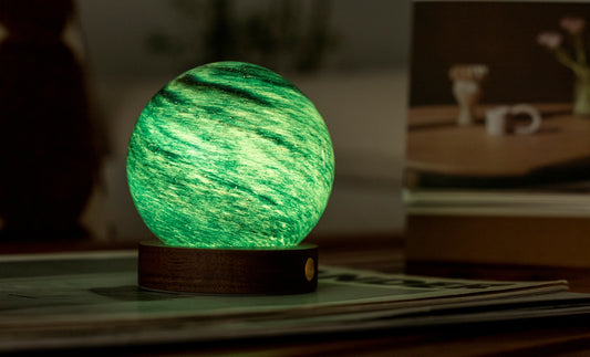 lampada AstraGlass Light. Composta da una sfera in vetro soffiata e dipinta a mano poggiata su una base rotonda in legno di noce americano. Questa lampada è perfetta per chiunque sia affascinato dal meraviglioso fenomeno naturale del nostro mondo. Dimensioni: cm ø 8 x h 9. In negozio e online su tuttochic.it