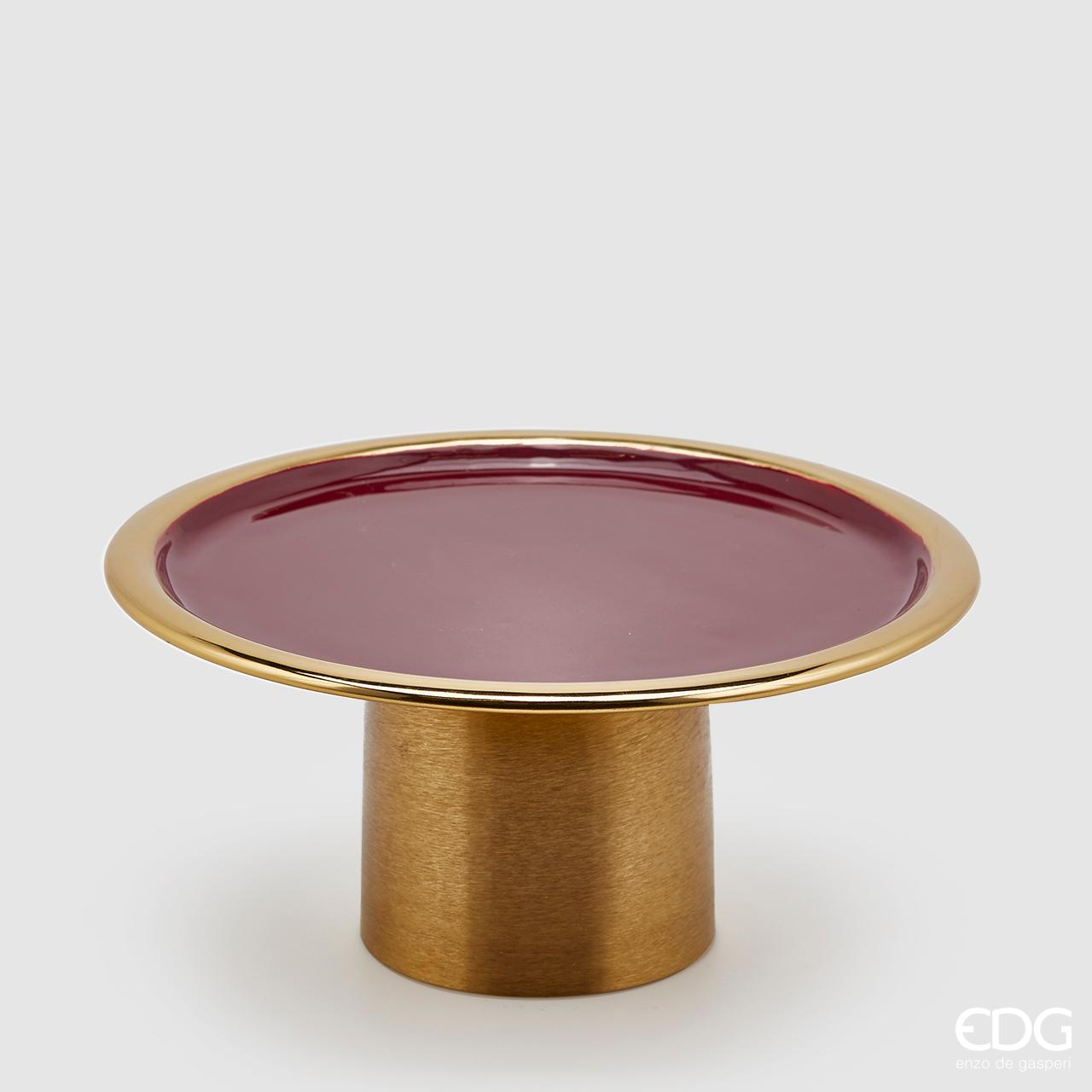 Alzata tonda in metallo color oro con piano smaltato di colore bordò. Dimensioni: cm diametro cm 29, altezza cm 14. In negozio e online su tuttochic.it