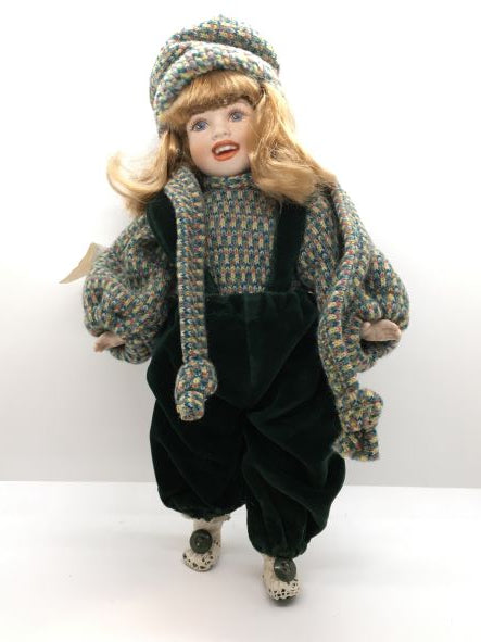 Bambola in porcellana di Capodimonte fatta e dipinta a mano, con mirabile fusione di tecnica e abilità manuale. Corpo, braccia e testa in porcellana snodabile, vestito con velluto verde scuro e cotone multicolorato. Dimensioni: cm 18 x 33 h. In negozio e online su tuttochic.it