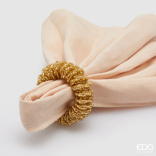 Legatovagliolo tondo decorato con perline in plastica color oro. Dimensioni: Ø cm 6. In negozio e online su tuttochic.it
