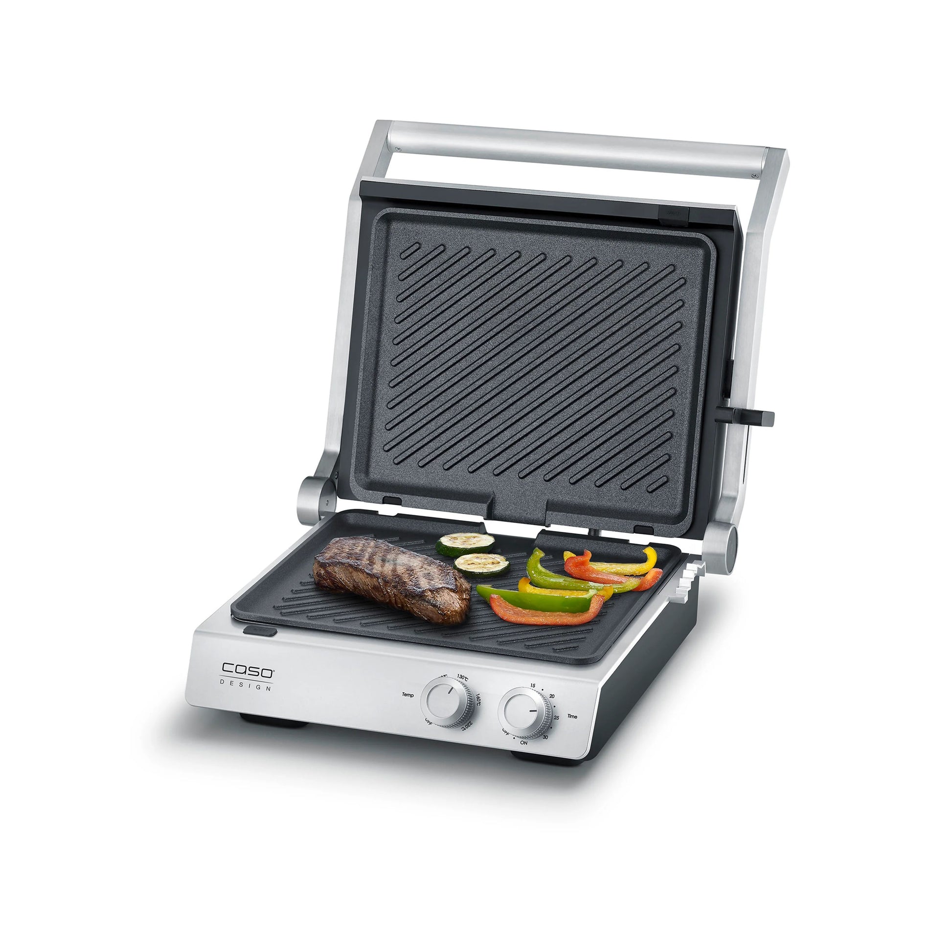 Piastra elettrica SteakChef CASO Design aperta su tavolo da cucina con bistecche in cottura