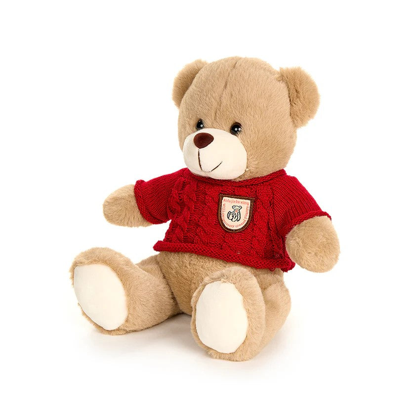 Splendido orsetto peluche "Bear Wonderland", vestito con un maglione colorato in morbido cotone e poliestere. Crea un'atmosfera natalizia con il nostro adorabile orsetto, perfetto come regalo o come decorazione per la tua casa. Dimensioni: cm 25. In negozio e online su tuttochic.it