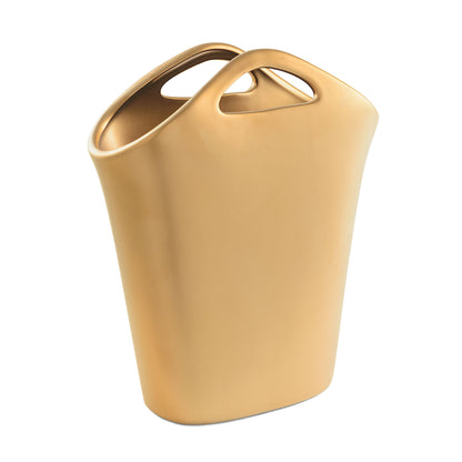 Esibisci il tuo gusto raffinato con il Vaso Borsa color oro opaco della collezione "LEGRAZIOSE" di Rituali Domestici . Realizzato in gres, questo vaso portafiori aggiunge un tocco di eleganza a qualsiasi ambiente. Dimensioni: cm 19 x 8.5 x 23 h. In negozio e online su tuttochic.it