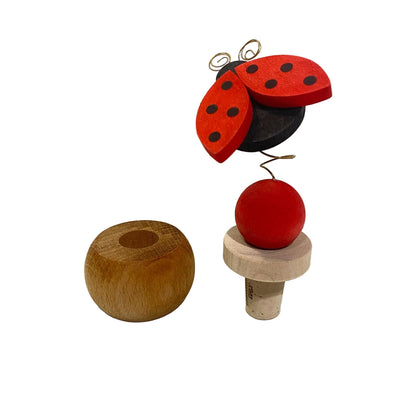 Tappo da vino in sughero e legno con coccinella rossa su molla e supporto reggitappo sferico in legno modello Coccinella di Legnomagia.