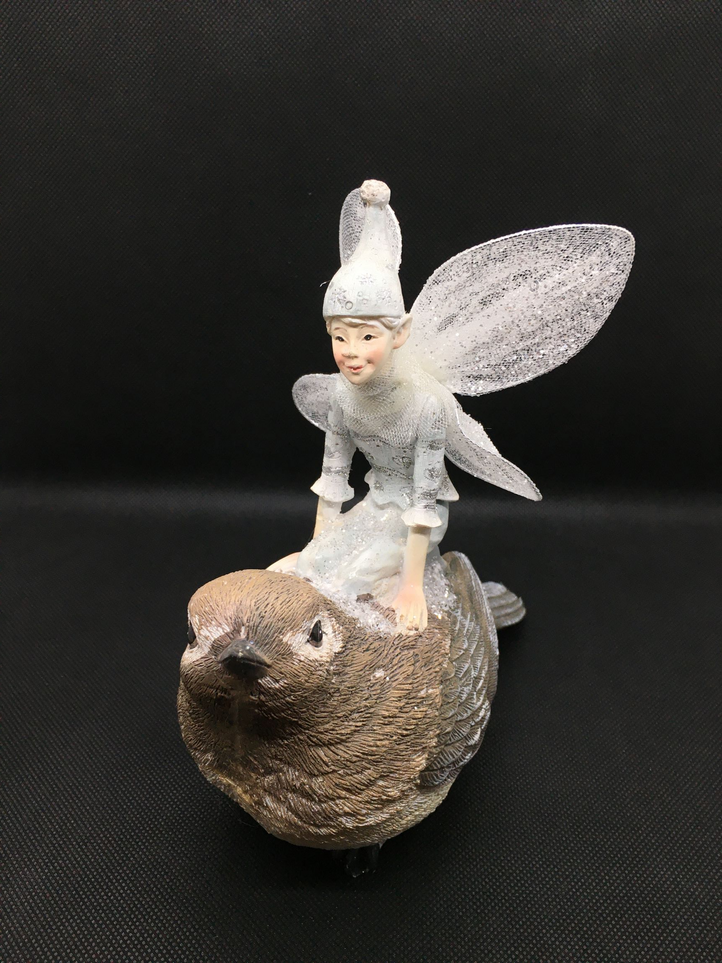 Fatina sul passero in resina decorata con glitter e ali in metallo e velo bianco. Dimensioni: cm 17 x 17