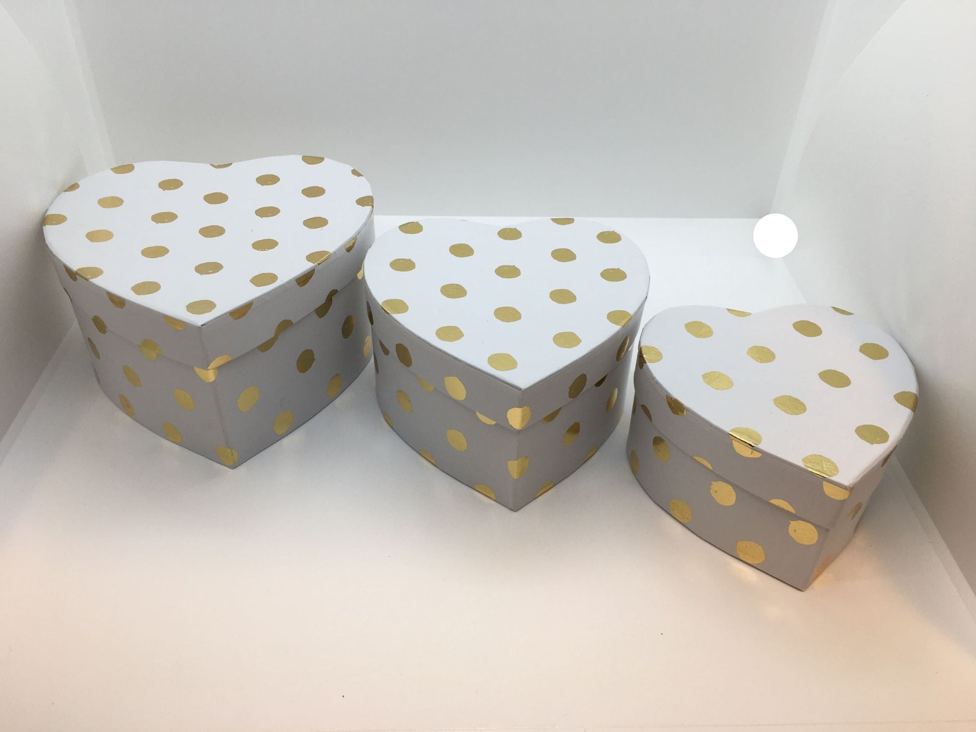 Set di 3 scatole regalo a forma di cuore in cartone bianco con decorazione pois color oro. Dimensione: scatola piccola cm 11 x 11 x 6 h scatola media cm 13 x 13 x 7 h scatola grande cm 15 x 15 x 8 h